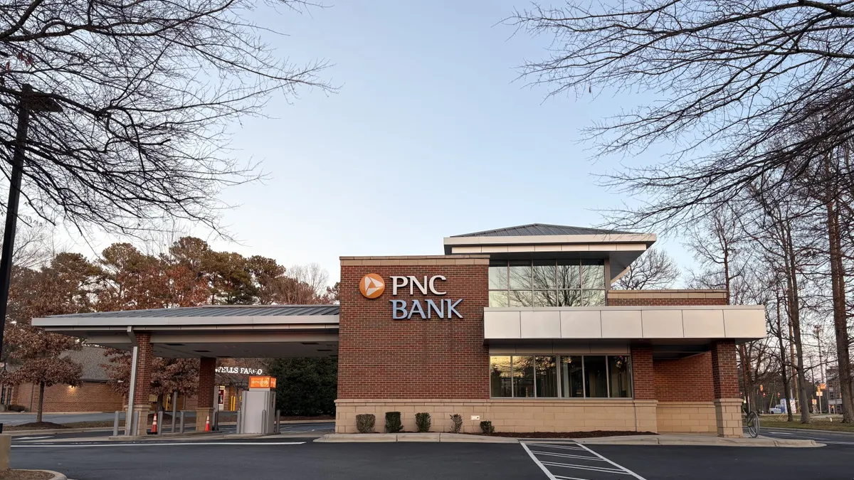 A brick and glass building is shown with the words "PNC Bank" and the PNC logo on the facade.
