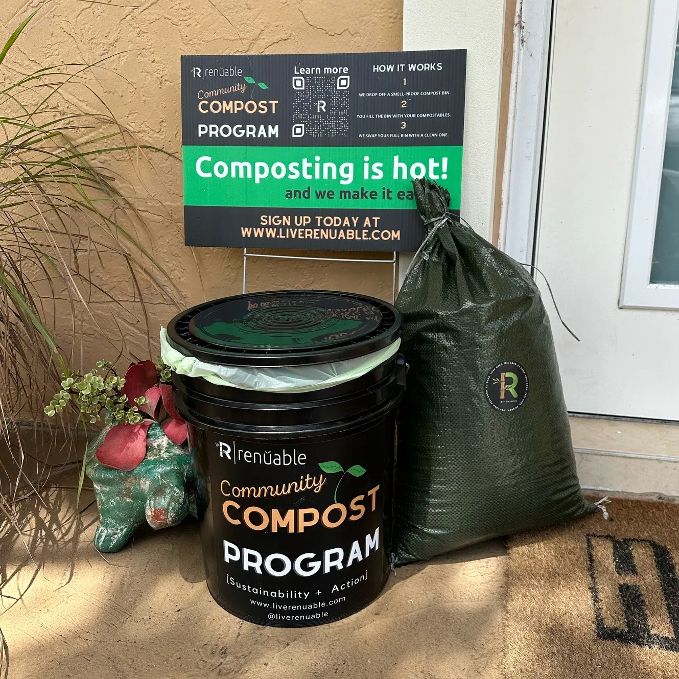 A food scrap collection bucket, bag of compost and sign for Renüable