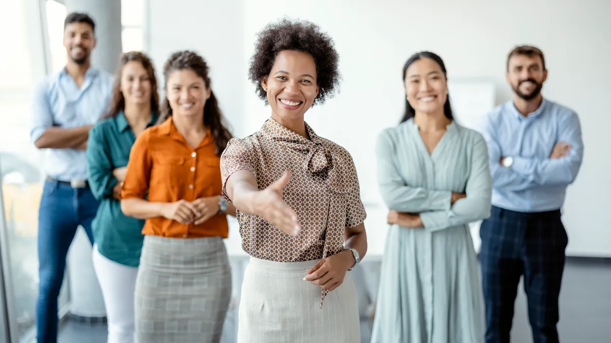 A group of businesspeople welcoming a new hire