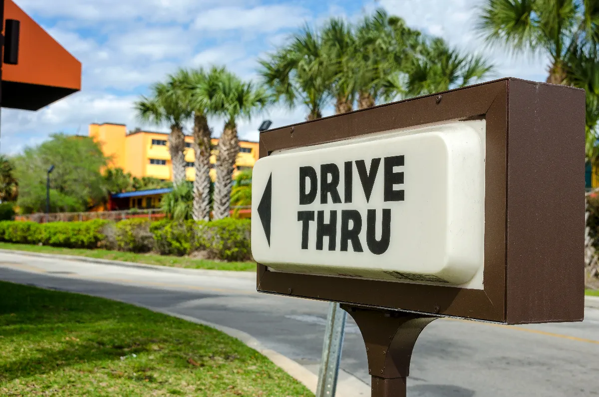 A drive thru sign advertising a fast food restaurant