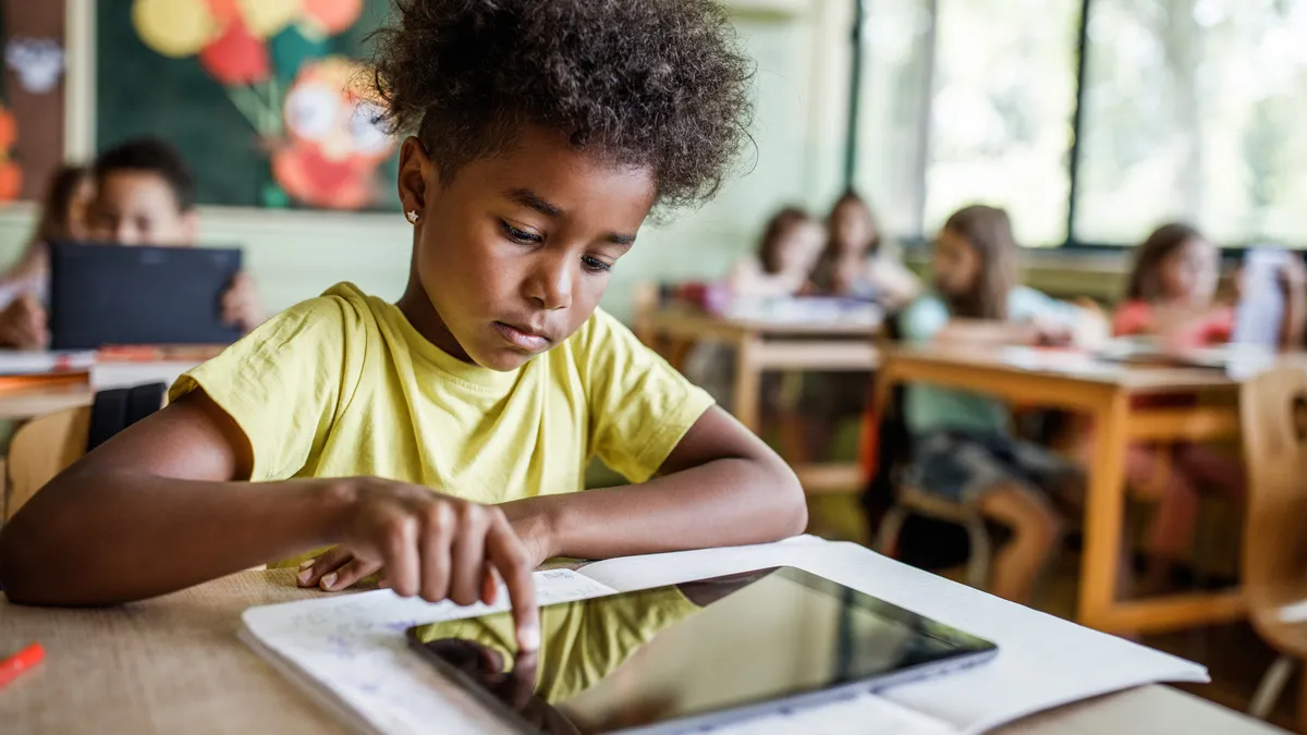 African American elementary student using touchpad on a class.