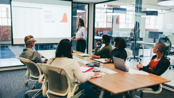 A business meeting being held in a company boardroom.