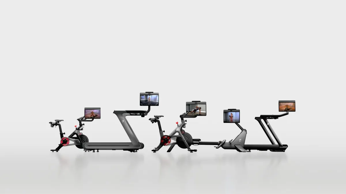 Four home workout machines with screens