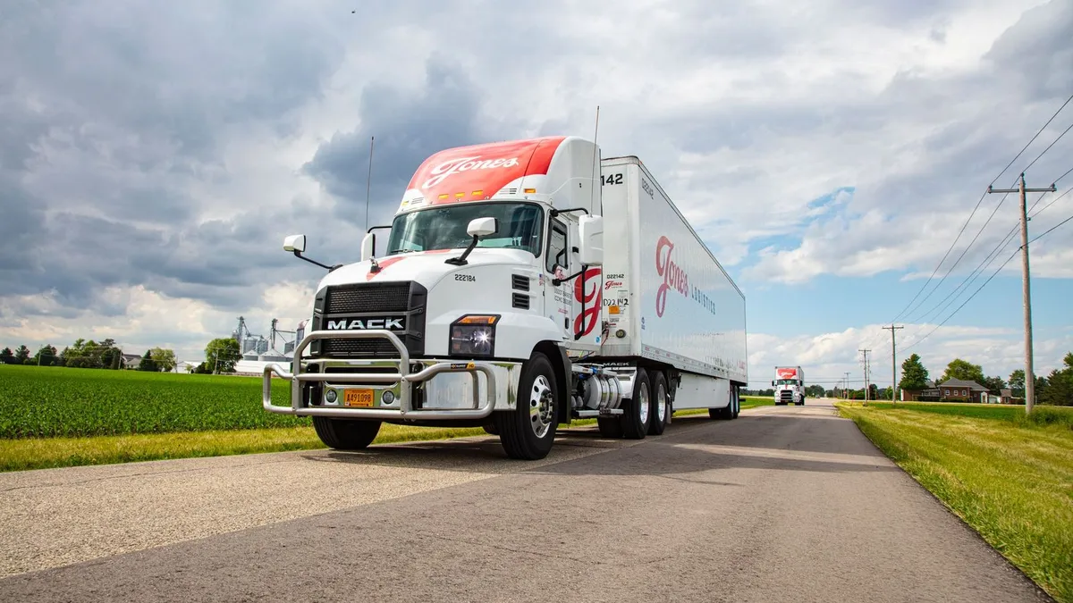 Jones Logistics trucks on a country road.