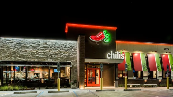 A nighttime photo of Chili's building with green and red neon signage