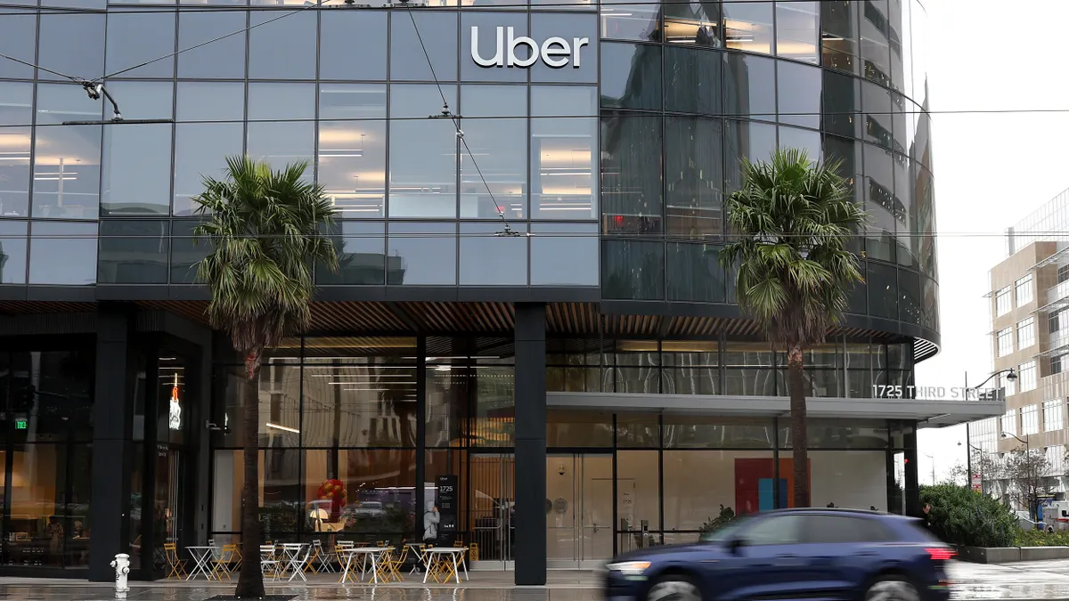A car drives by Uber headquarters on February 07, 2024 in San Francisco, California.