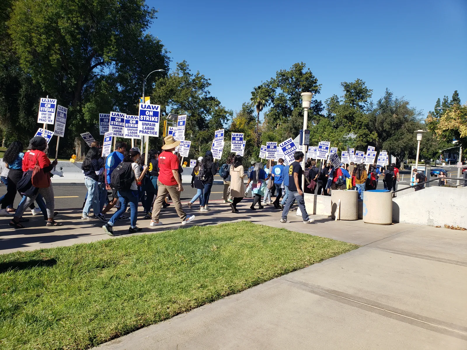 People march with picket signs.