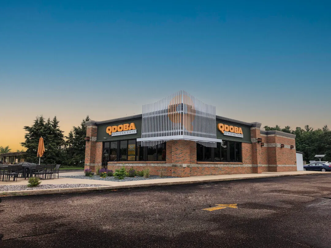 A Qdoba store around dusk.