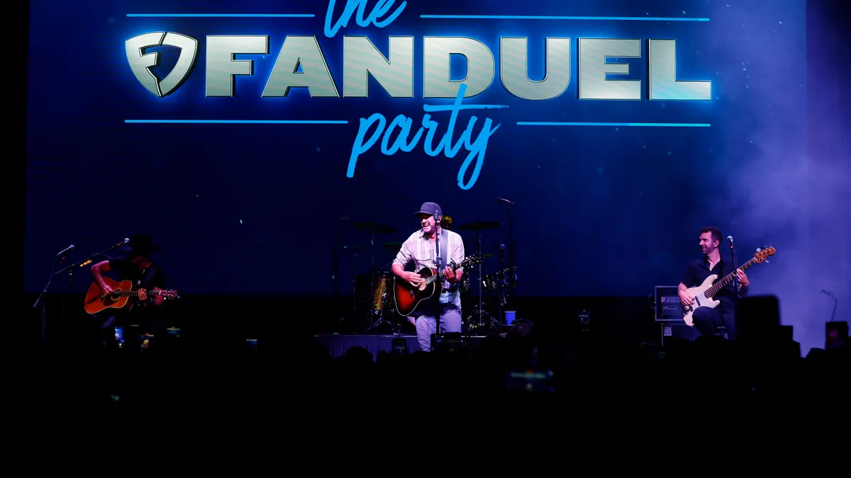 Luke Bryan performing on stage for a FanDuel brand party at the 2024 Kentucky Derby