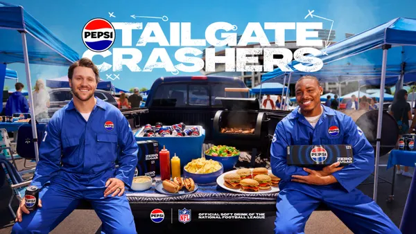 NFL players Josh Allen and Justin Jefferson sit at a tailgate in a parking lot wearing blue Pepsi jumpsuits
