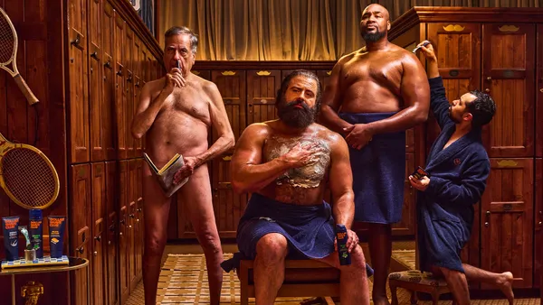 Four men in various states of undress pose in a Dollar Shave Club ad