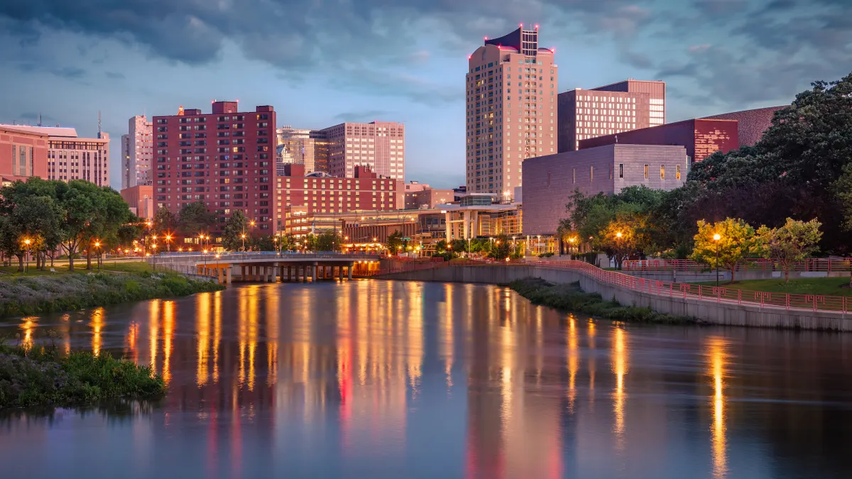 A city skyline with a body of water in the foreground.