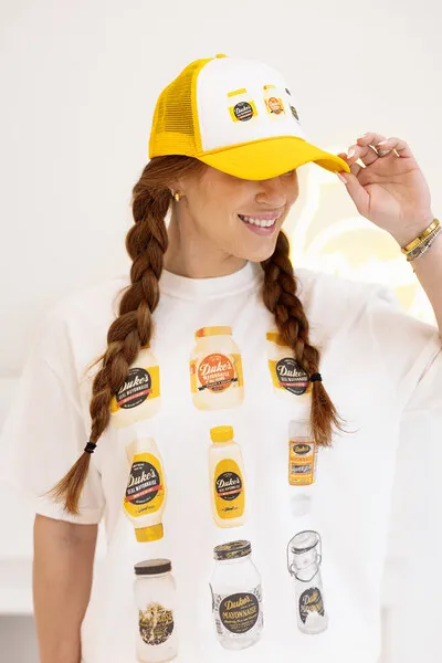 A girl wearing a hat and tee from the Duke's Mayo collection by Girl Tribe Co.