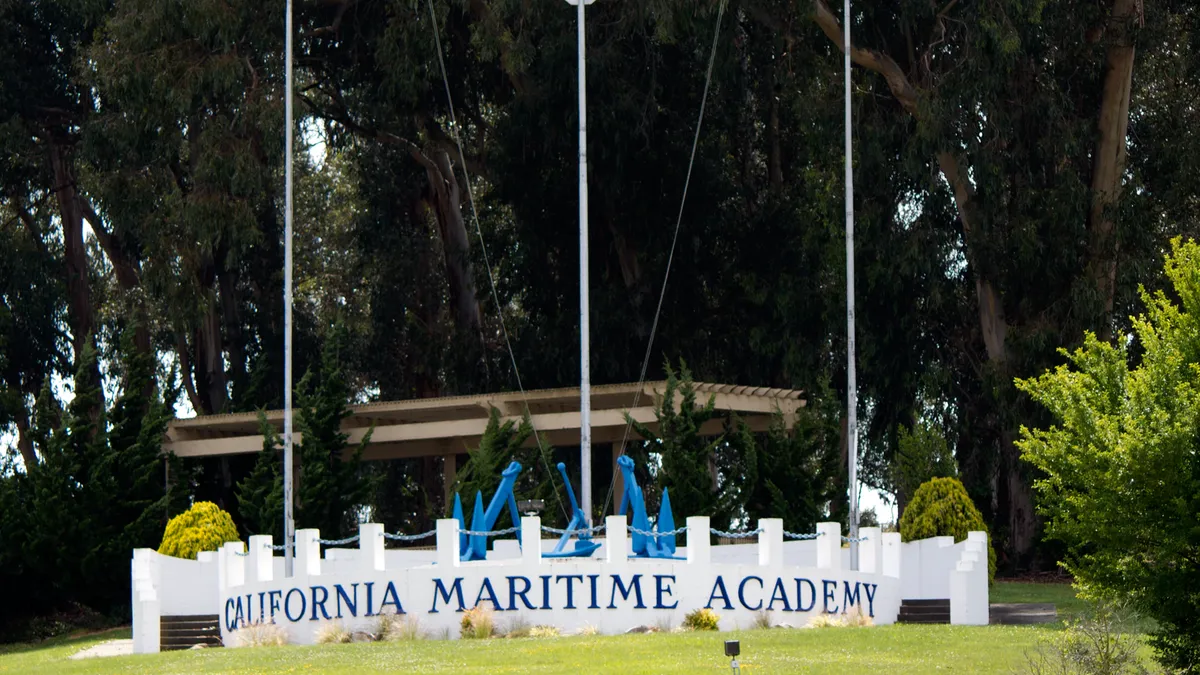 California Maritime Academy sign under a model sail.