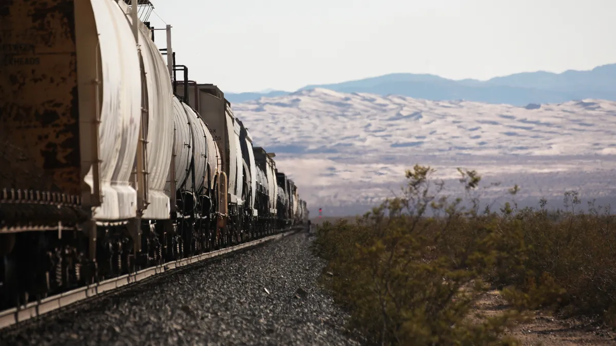 A train moves through a desert landscape