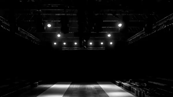 A darkened, empty stage at a fashion show.