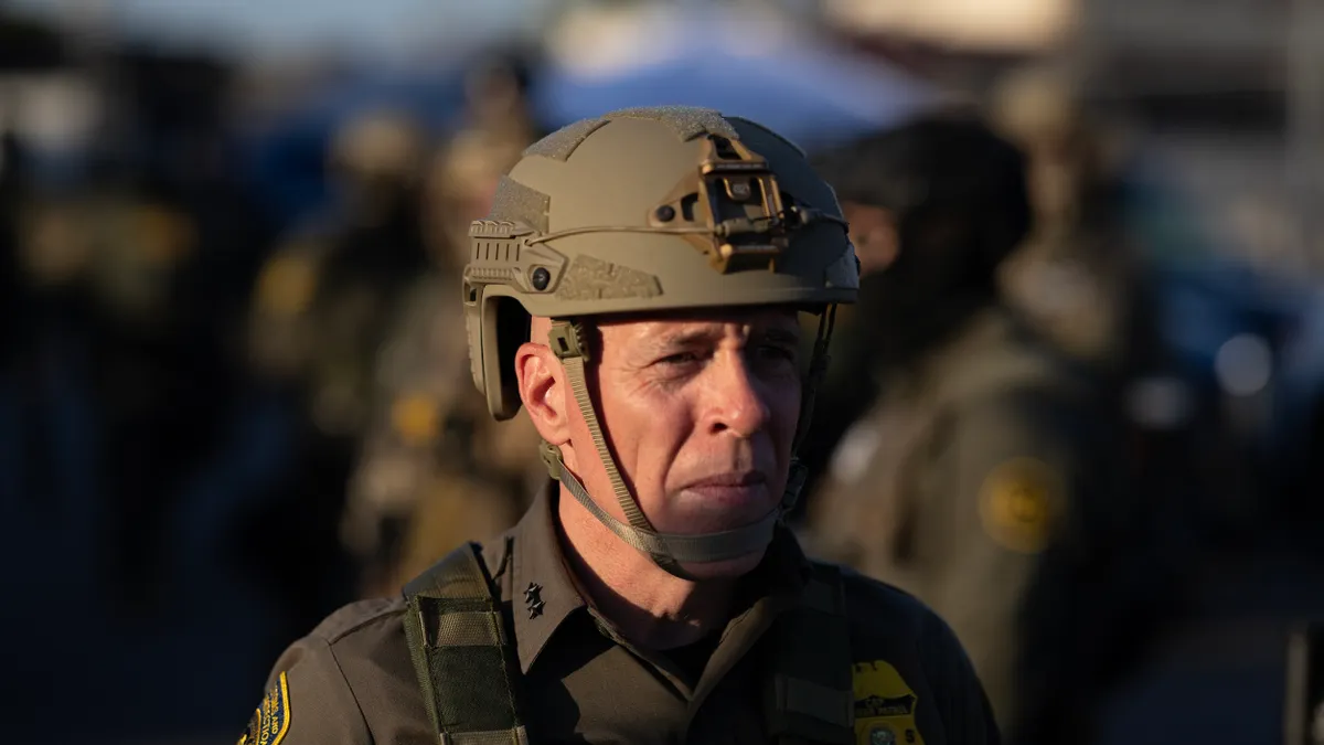 A man wearing military fatigues and a helmet
