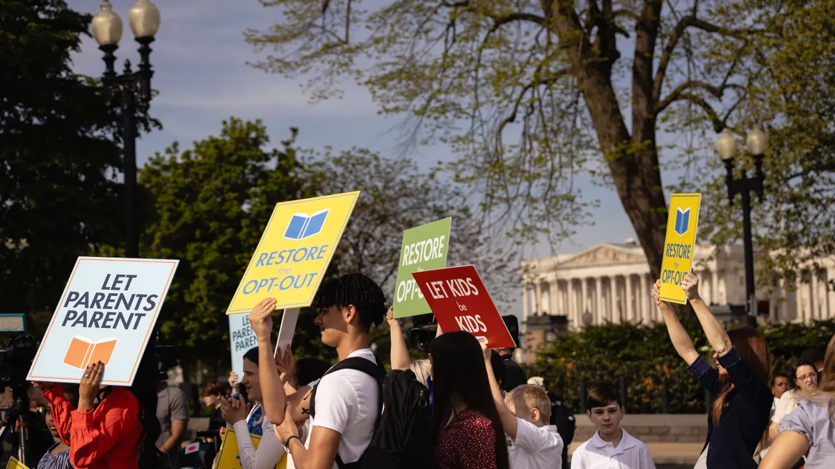 Parents, students and others rally in front of the U.S. Supreme Court holding signs like "Let Parents Parent"