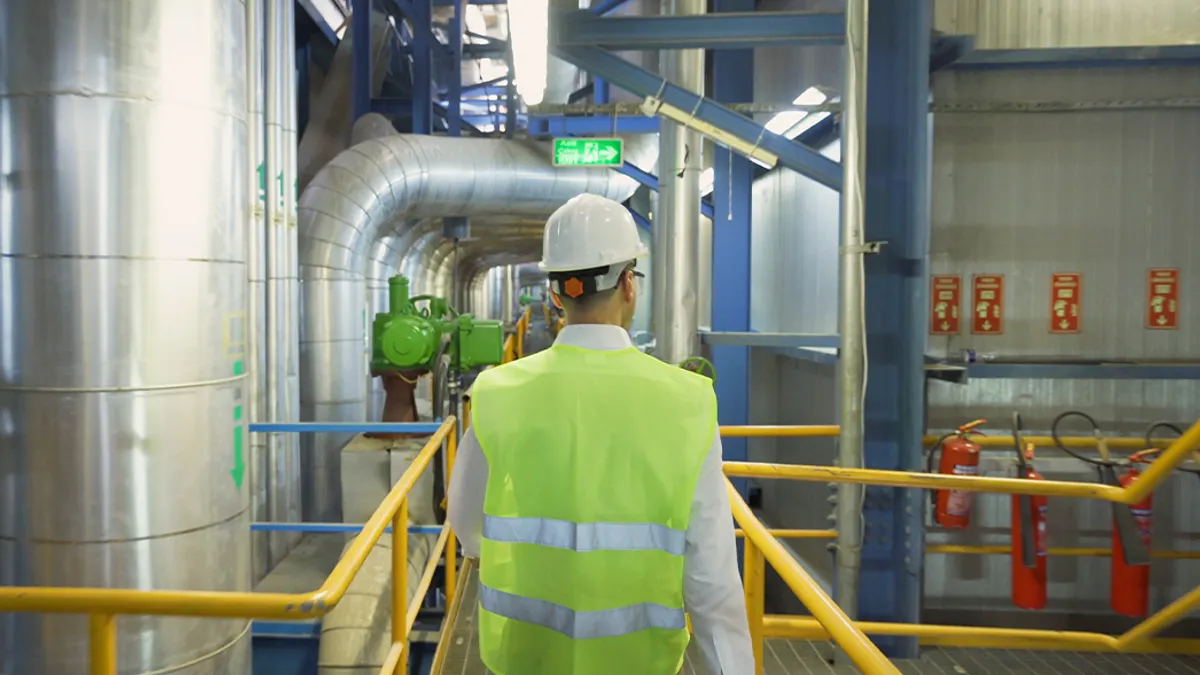 Factory worker walking through factory