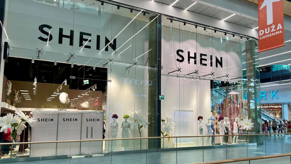 A Shein storefront in a mall. The windows read Shein and there are mannequins.