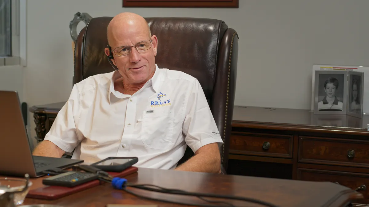 RREAF Holdings’ CFO Mitch Provosty in his office and sitting behind his desk.