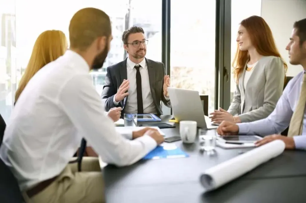 Corporate business people in meeting with group.