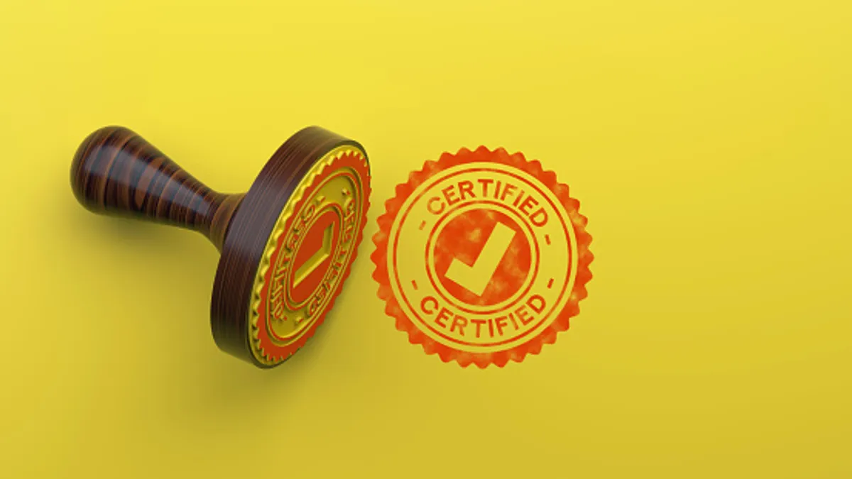 Rubber stamp on yellow background that says, 'certified'