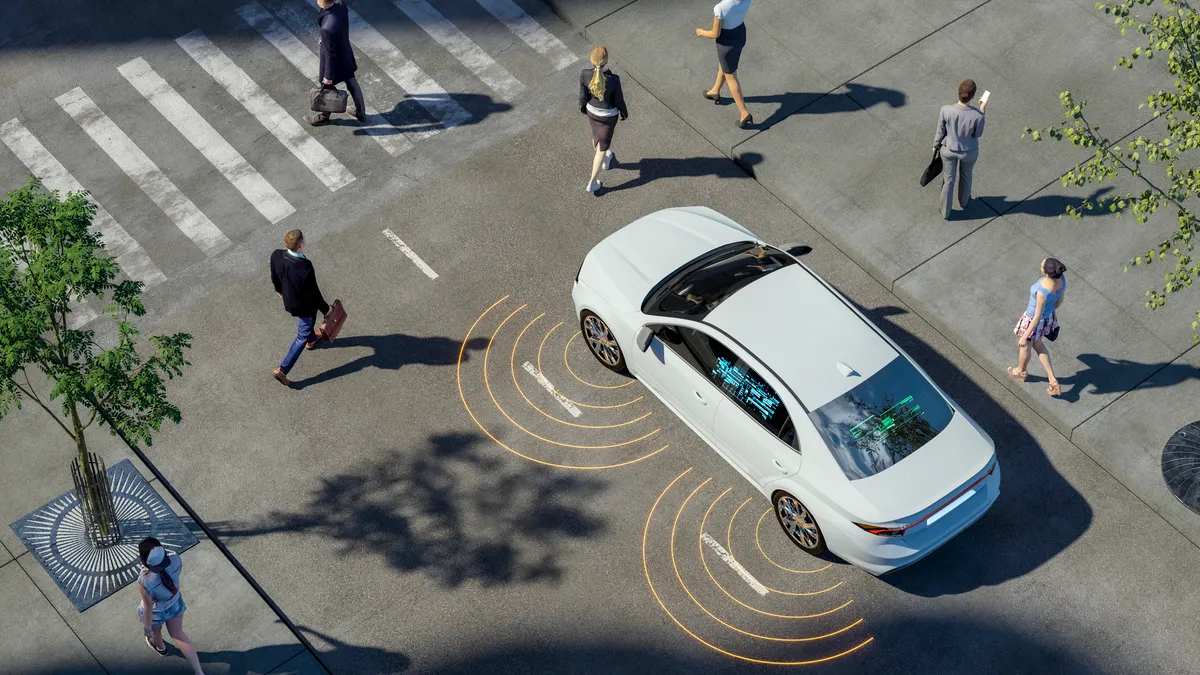 An artist's rendering of a city streetscape. A high-tech car approaches a crosswalk as pedestrians pass by.