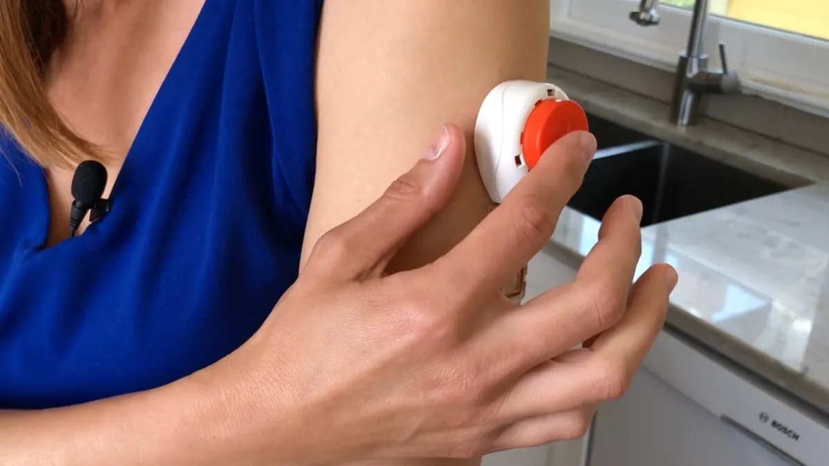 A woman using a Tasso blood collection device