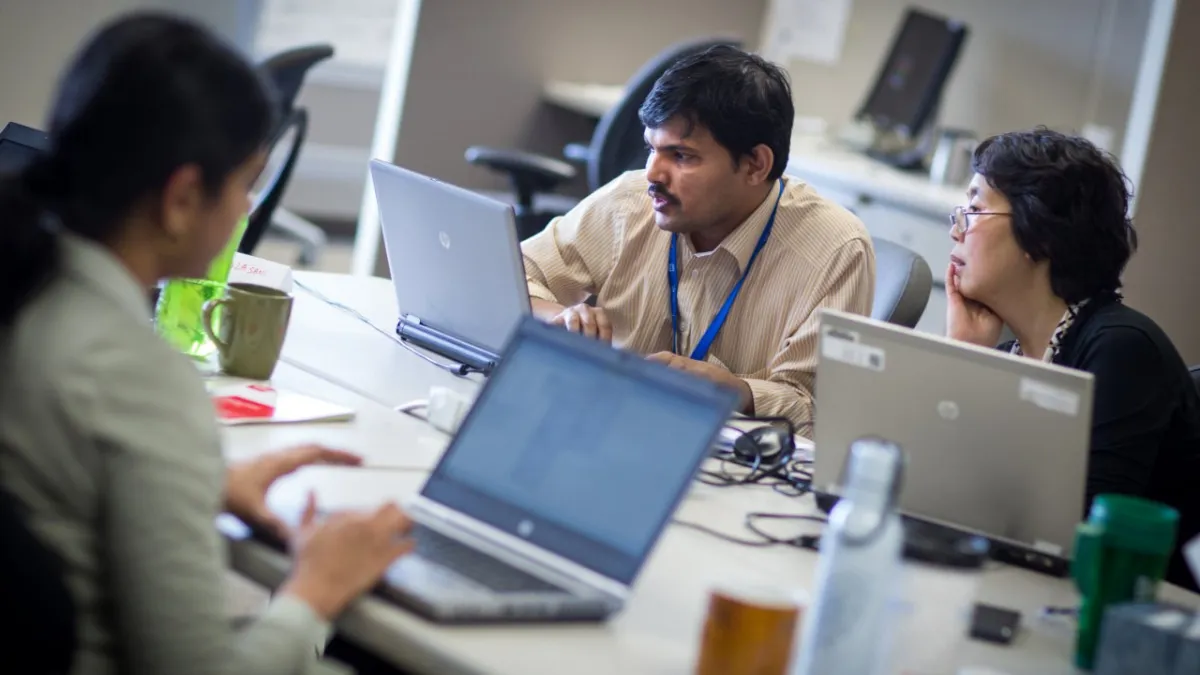 Workers collaborate at the GMIT Michigan Innovation Center, located in the Cadillac Building on the General Motors Tech Center campus