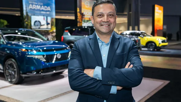 Ponz Pandikuthira, Nissan Americas Senior VP, at an auto show stand
