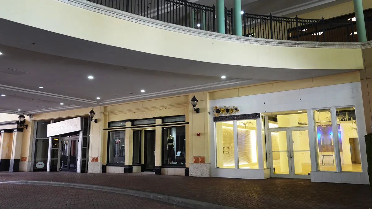 A mall with empty storefronts.