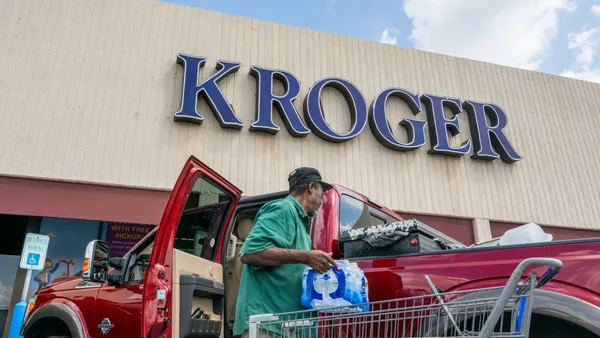 A shopper loads his truck in front of a Kroger.
