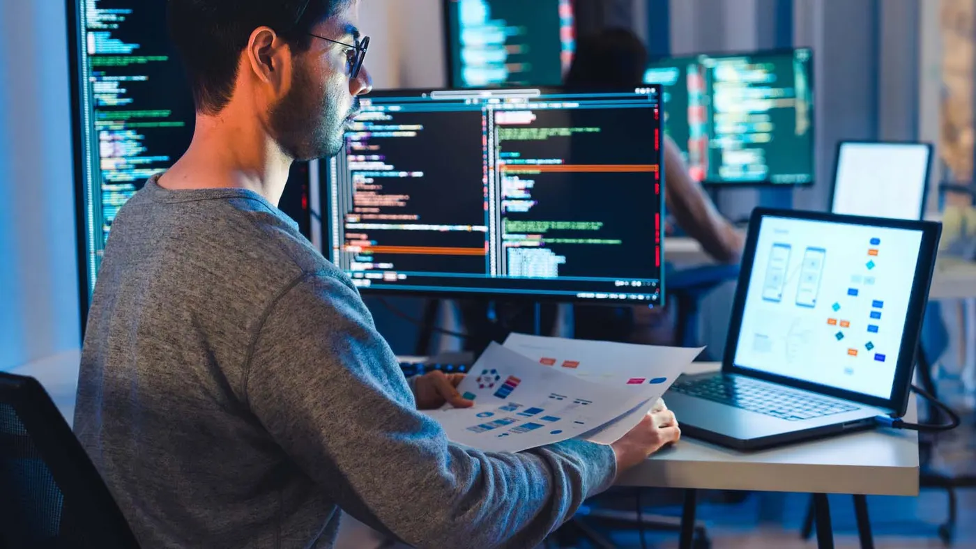 software developers working on multiple screens