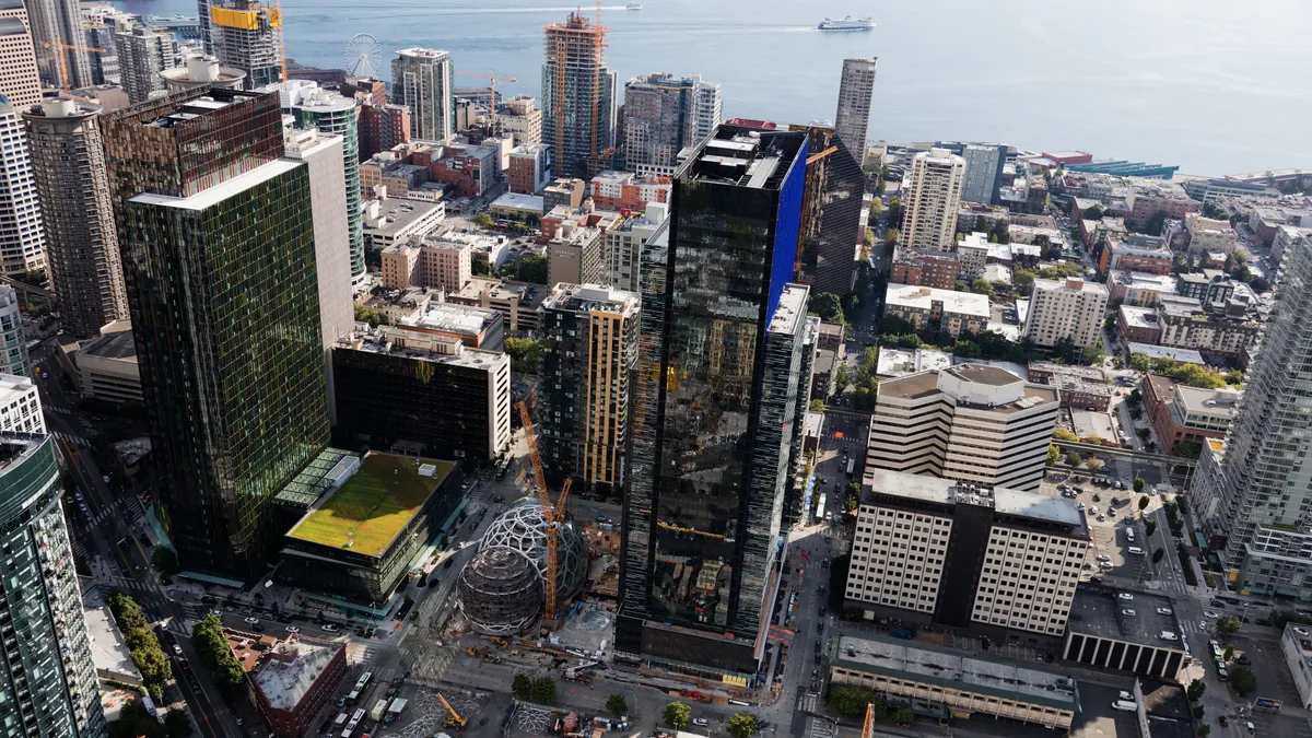 An aerial view of Seattle showing a cluster of buildings and Puget Sound.