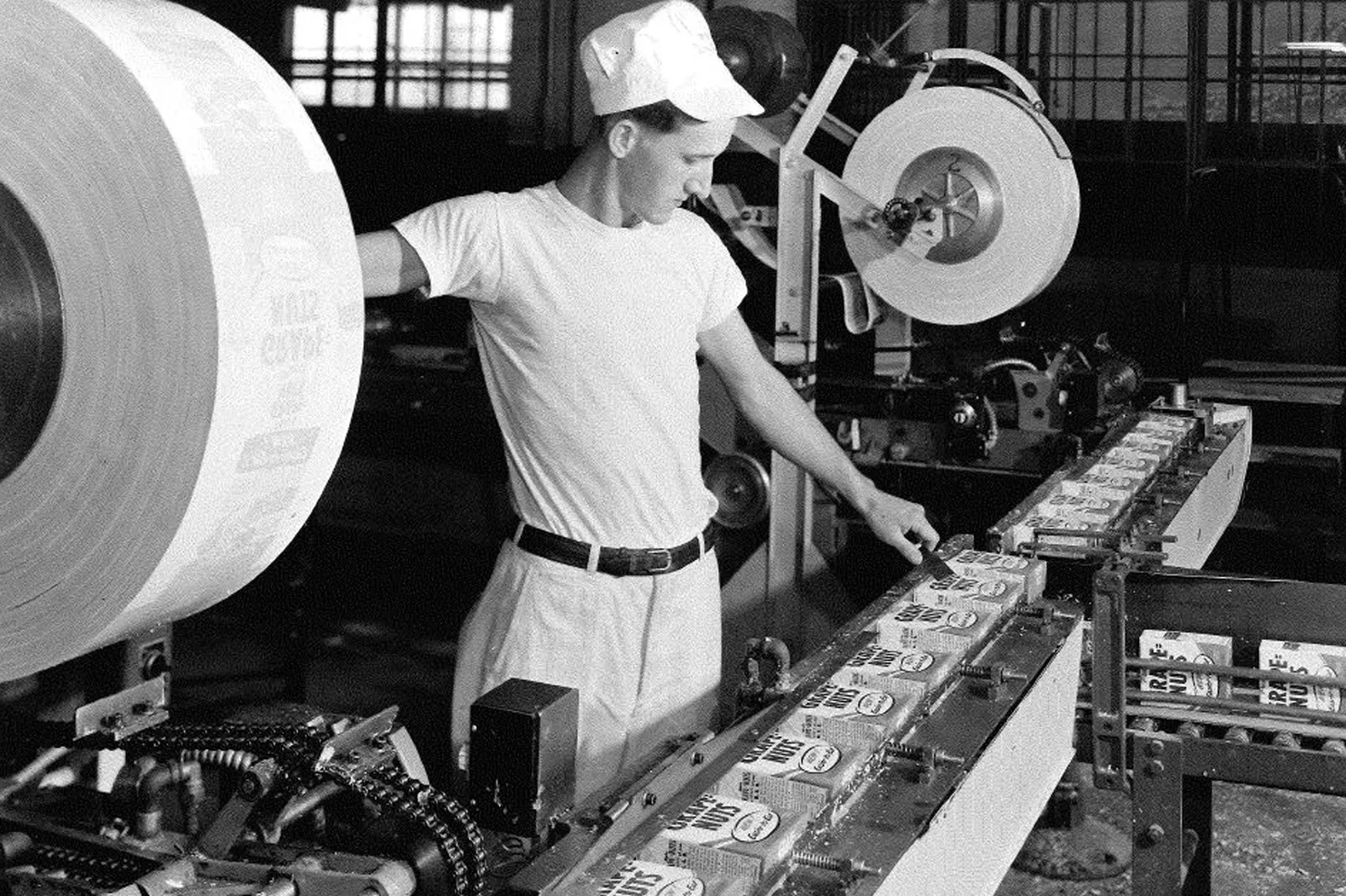 A Post employee works in a factory with Grape-Nuts cereal moving down the line in Michigan.