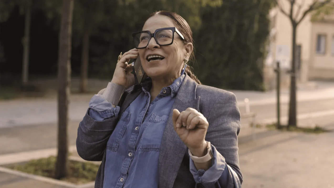 A woman speaking on the phone outside