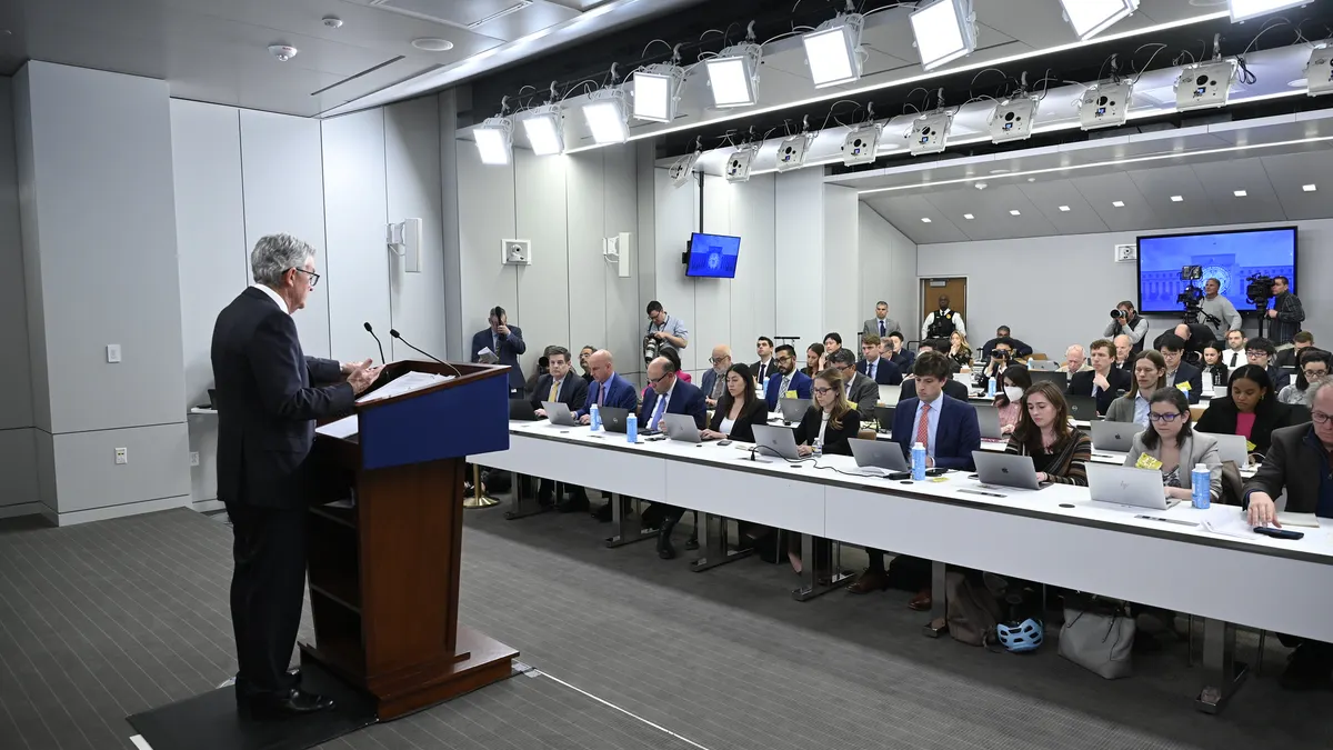 A photo of Fed Chair Jerome Powell speaks at a May 2023 press conference facing the audience of reporters