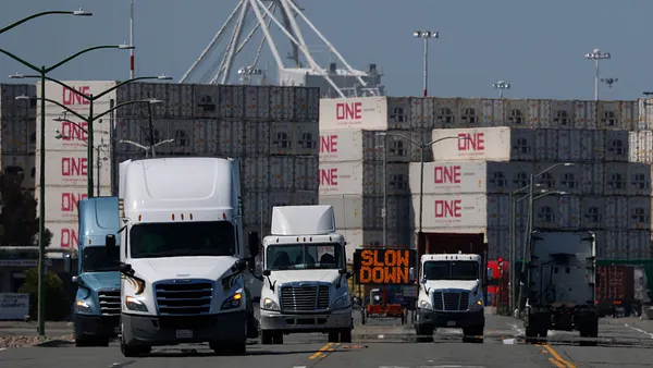 Multiple tucks drive through the Port of Oakland.