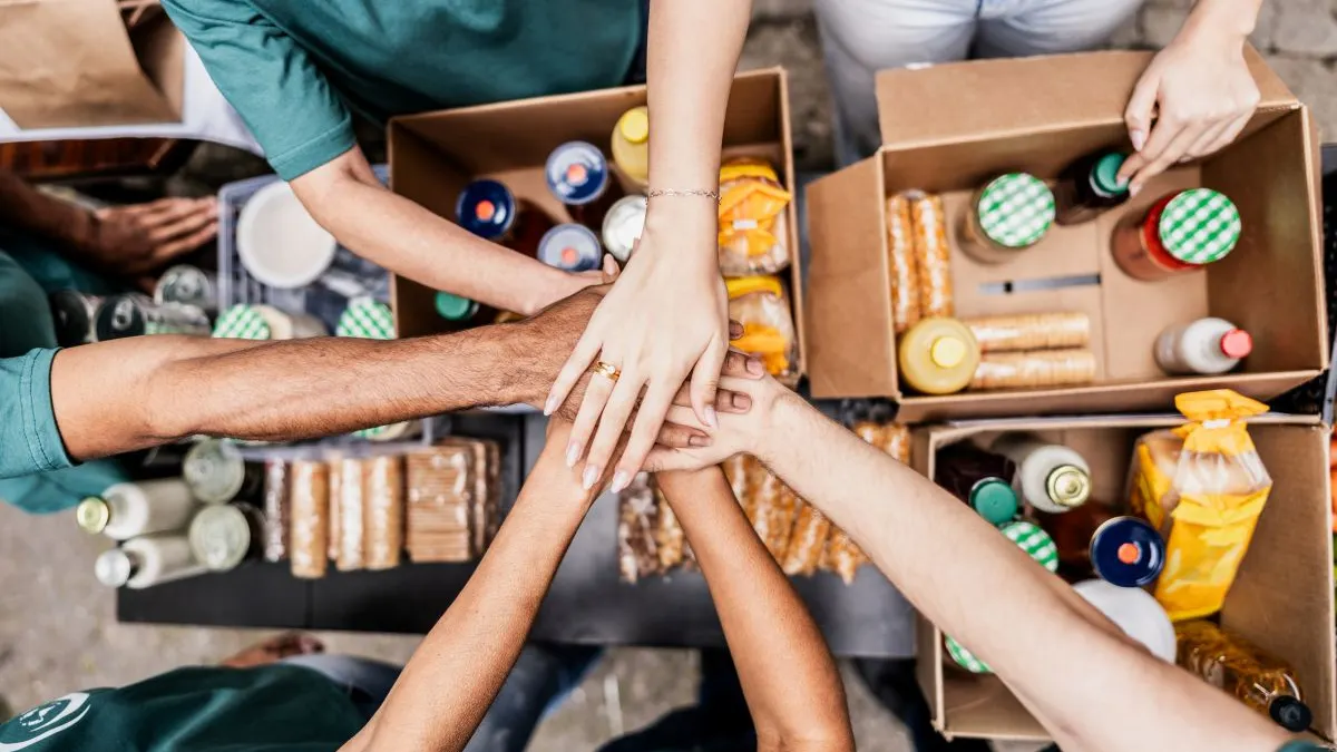 nonprofit working hands touching boxes