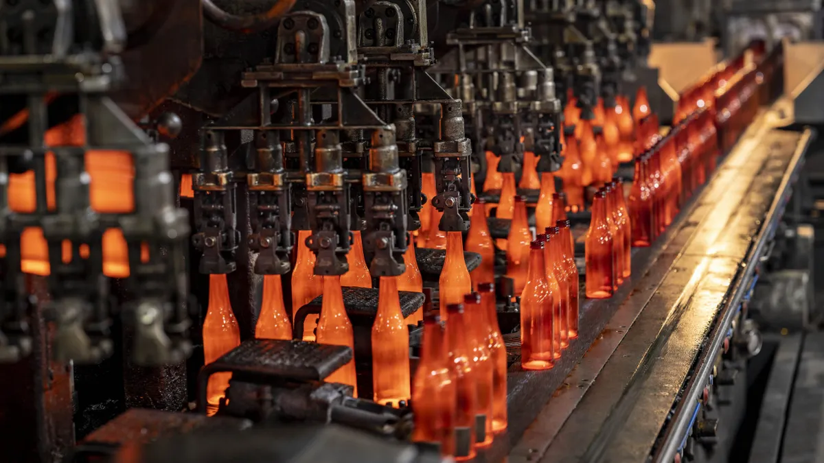 O-I glass bottles on the hot end of a line.