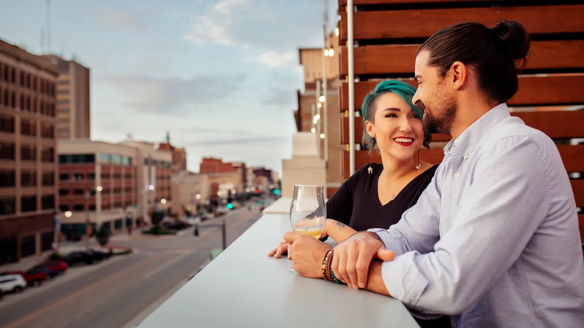 Two people enjoy cocktails on a rooftop in Topeka, Kansas.