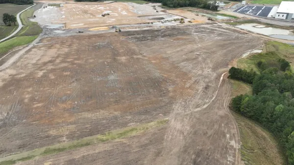 A view showing the development of an industrial center with a leveled construction area.
