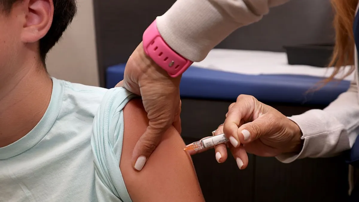 A child receives a standard immunization at Dr. Gary Kramer's pediatric office on September 15, 2025, in Coral Gables, Florida.