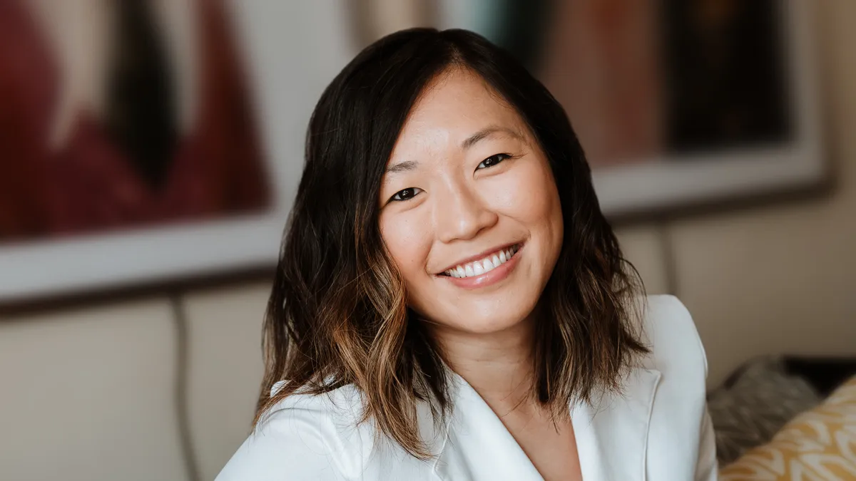 A woman smiles at the camera.