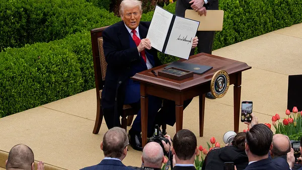 U.S. President Donald Trump holds his executive order imposing tariffs.