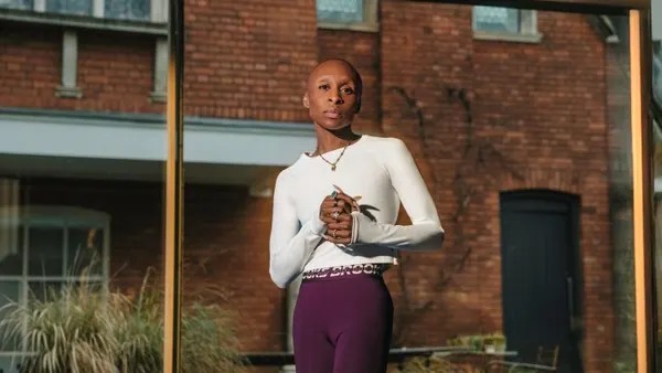 Actor Cynthia Erivo, wearing Brooks Running workout gear, looks directly into the camera in an outdoor photo shoot