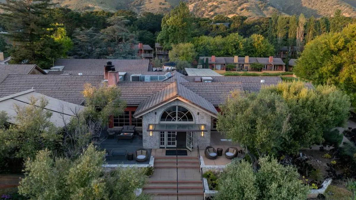 The exterior of the hotel with mountains in the background.
