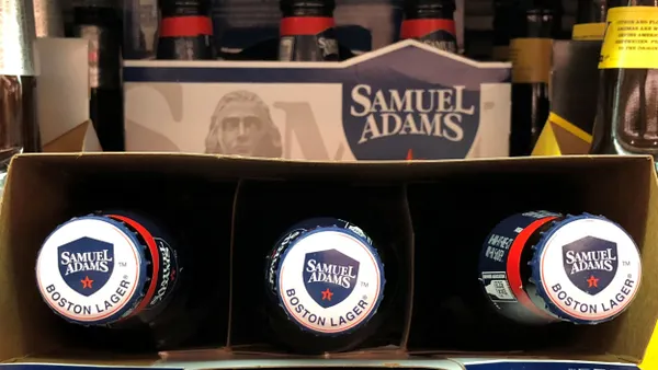 A six pack of Samuel Adams beer bottles is seen on a store shelf.