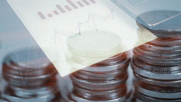 Double exposure of coin stack and notebook laptop computer with financial graph on white paper business planning vision and finance analysis concept